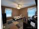 Neutral bedroom with a ceiling fan and large windows at 117 Cove Ave, Mount Holly, NC 28120