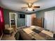 Comfortable bedroom has a ceiling fan, a TV, and an ensuite bathroom at 117 Cove Ave, Mount Holly, NC 28120