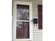 Close-up of the front door with mailbox and shuttered window at 117 Cove Ave, Mount Holly, NC 28120