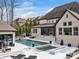 Luxury backyard with a swimming pool, fire pit, outdoor seating, dining area, and lush landscaping at 1238 Ladera Dr, Waxhaw, NC 28173