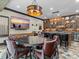 Basement bar with ample seating, wooden cabinets, countertop and TV at 1238 Ladera Dr, Waxhaw, NC 28173
