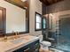 Modern bathroom featuring a glass shower, black mosaic tiles, a marble countertop, and gold fixtures at 1238 Ladera Dr, Waxhaw, NC 28173