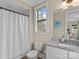 Cozy bathroom with neutral walls, shower with white curtain, granite counters and window at 1238 Ladera Dr, Waxhaw, NC 28173