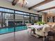 Bright dining area with pool view, featuring floor-to-ceiling windows and stylish decor at 1238 Ladera Dr, Waxhaw, NC 28173