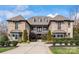 Elegant stone home featuring manicured landscaping and symmetrical design elements, with a welcoming front entrance and charming architectural details at 1238 Ladera Dr, Waxhaw, NC 28173