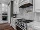 Well-equipped kitchen with stainless steel appliances, white cabinetry, and marble countertops at 1238 Ladera Dr, Waxhaw, NC 28173