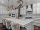 Stylish kitchen with white cabinets, a marble island, and designer pendant lighting at 1238 Ladera Dr, Waxhaw, NC 28173