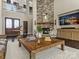 Elegant living room with a stone fireplace, dark hardwood floors, and a cozy seating area at 1238 Ladera Dr, Waxhaw, NC 28173