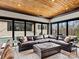 Open living area with a hardwood ceiling, leather sectional, large windows offering natural light, and views of backyard at 1238 Ladera Dr, Waxhaw, NC 28173