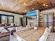 Spacious living room with hardwood ceilings, stone fireplace, dining table, and a comfortable leather sectional at 1238 Ladera Dr, Waxhaw, NC 28173