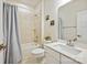 Well-lit bathroom with a shower-tub combination, white vanity, and neutral tile at 1332 Augustus Beamon Dr, Indian Trail, NC 28079