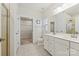 Bright bathroom with double vanity, walk-in closet, and neutral tile at 1332 Augustus Beamon Dr, Indian Trail, NC 28079