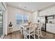 Cozy dining area features modern table and chairs, adjacent to bright kitchen and natural light at 1332 Augustus Beamon Dr, Indian Trail, NC 28079