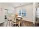 Bright dining area featuring sliding door access to backyard and modern kitchen at 1332 Augustus Beamon Dr, Indian Trail, NC 28079