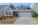 Charming home with stone accents, well-manicured landscaping, and a spacious two-car garage at 1332 Augustus Beamon Dr, Indian Trail, NC 28079
