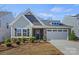 Attractive exterior featuring stone accents, a well-manicured lawn, and tasteful landscaping at 1332 Augustus Beamon Dr, Indian Trail, NC 28079