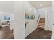 Inviting hallway featuring wood floors and a staircase at 1332 Augustus Beamon Dr, Indian Trail, NC 28079