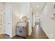 Hallway featuring wood flooring, white walls, and an accent table with decor at 1332 Augustus Beamon Dr, Indian Trail, NC 28079