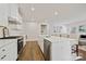 Bright kitchen with a center island, modern appliances, white cabinets and a view into the living space at 1332 Augustus Beamon Dr, Indian Trail, NC 28079