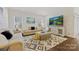 Inviting living room with ample seating, a TV, stylish decor, and plenty of natural light at 1332 Augustus Beamon Dr, Indian Trail, NC 28079