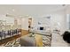 Bright living room with modern decor, comfortable seating, and an adjacent open-concept kitchen area at 1332 Augustus Beamon Dr, Indian Trail, NC 28079
