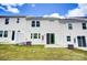 A well-manicured backyard with green lawn and white siding, perfect for outdoor enjoyment at 14726 Tamarack Dr, Charlotte, NC 28278