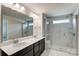 Bathroom featuring double sink vanity and glass enclosed shower at 14726 Tamarack Dr, Charlotte, NC 28278