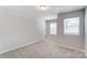 Comfortable bedroom featuring neutral carpet, and lots of natural light at 14726 Tamarack Dr, Charlotte, NC 28278