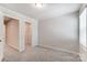 A cozy bedroom with neutral carpet and a walk-in closet, perfect for relaxation at 14726 Tamarack Dr, Charlotte, NC 28278