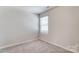 Bright bedroom with large window, neutral carpet, and natural light at 14726 Tamarack Dr, Charlotte, NC 28278