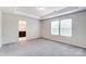 Spacious bedroom with tray ceiling and large windows for natural light at 14726 Tamarack Dr, Charlotte, NC 28278