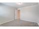 Bedroom with neutral carpet and an open doorway at 14726 Tamarack Dr, Charlotte, NC 28278