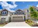 Charming townhome featuring a two-car garage, landscaped yard, and a mix of stone and vinyl siding at 14726 Tamarack Dr, Charlotte, NC 28278