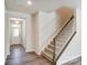 Inviting foyer with wood-look floors, stairs leading to the upper level, and a view of the front door at 14726 Tamarack Dr, Charlotte, NC 28278