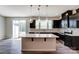 Kitchen with white backsplash, modern lighting, stainless appliances at 14726 Tamarack Dr, Charlotte, NC 28278