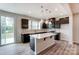 Modern kitchen with dark cabinetry, an island, and pendant lighting at 14726 Tamarack Dr, Charlotte, NC 28278