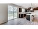 Stylish kitchen with dark cabinets, stainless appliances, an island, and a sliding door to a backyard patio at 14726 Tamarack Dr, Charlotte, NC 28278