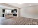 Modern kitchen with stainless appliances, dark cabinetry, an island, and an open view to the dining area at 14726 Tamarack Dr, Charlotte, NC 28278