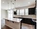Spacious kitchen featuring an island with quartz countertop and dark cabinets at 14726 Tamarack Dr, Charlotte, NC 28278