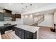 Kitchen featuring a white quartz island, stainless appliances and dark cabinets at 14726 Tamarack Dr, Charlotte, NC 28278