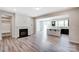 Open-concept living room with fireplace, flowing into the kitchen with an island and modern appliances at 14726 Tamarack Dr, Charlotte, NC 28278