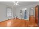 Bright bathroom with a tiled shower, white cabinets, and classic hardwood floors at 1489 Riley St, Albemarle, NC 28001