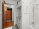 Bathroom with an open door to another room, shower, and a hanging rack to dry at 1489 Riley St, Albemarle, NC 28001