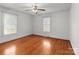 Cozy bedroom with hardwood floors, two windows, and a ceiling fan at 1489 Riley St, Albemarle, NC 28001