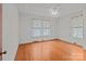 Bright bedroom with hardwood floors, two windows, and a classic ceiling fan at 1489 Riley St, Albemarle, NC 28001