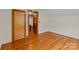 Cozy bedroom featuring hardwood floors, closet, and entry with natural wood trim at 1489 Riley St, Albemarle, NC 28001