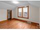 Bedroom featuring two windows and hardwood floors and wooden trim around the room at 1489 Riley St, Albemarle, NC 28001