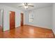 Bedroom featuring hardwood floors, white walls, a ceiling fan and two closets at 1489 Riley St, Albemarle, NC 28001