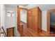 Hallway with wooden floors, built in cabinets, and a view of the staircase at 1489 Riley St, Albemarle, NC 28001
