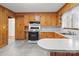 Updated kitchen with gas range, wood cabinets and white countertop with tile flooring at 1489 Riley St, Albemarle, NC 28001